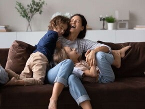 Madre jugando con sus hijos en casa