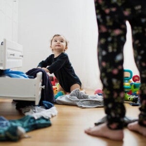 young child looking through clothes drawers young child looking through clothes drawers