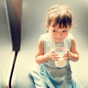 Niña tomando leche Niña tomando leche para tener defensas fuertes