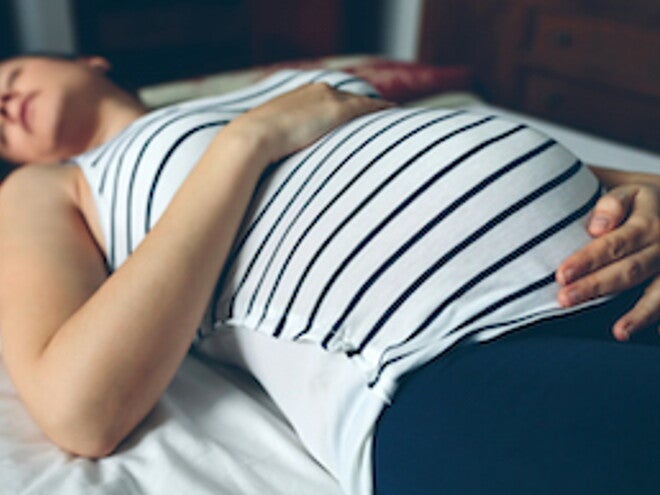 Mujer embarazada acostada embarazo de alto riesgo