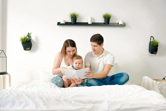 Mamá y papá leyendo un cuento a su bebé