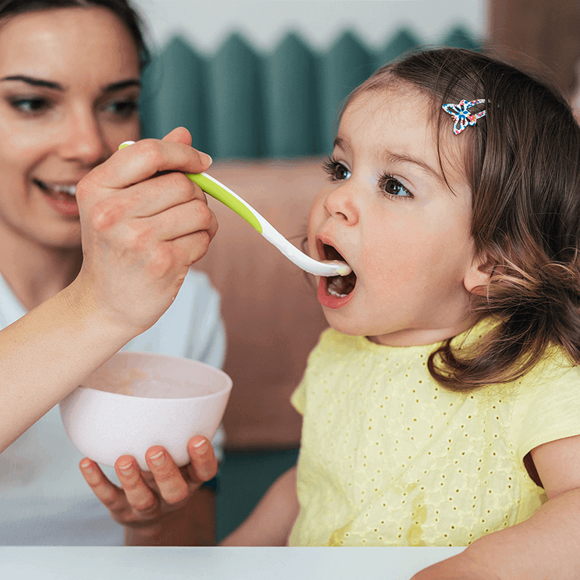 Mamá alimentando a su hija Mamá alimentando a su hija